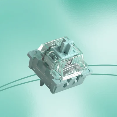 A single transparent glass or acrylic switch keycap shown floating against a soft mint-green gradient background.