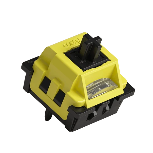 A yellow and black switch module with a clear lens window, shown on a solid white background.