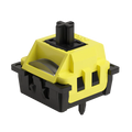 A mechanical keyboard switch module with a bright yellow top plate and a black base, featuring a visible silver ribbon cable and a black actuator pin on a plain white background.