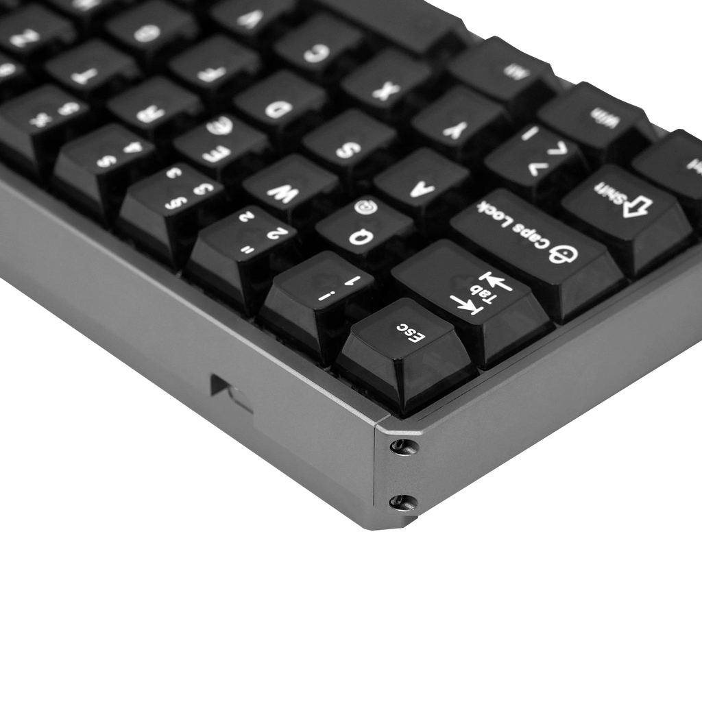 Close-up of a black mechanical keyboard with a dark gray metallic frame, showing the corner and keycaps on a white background.
