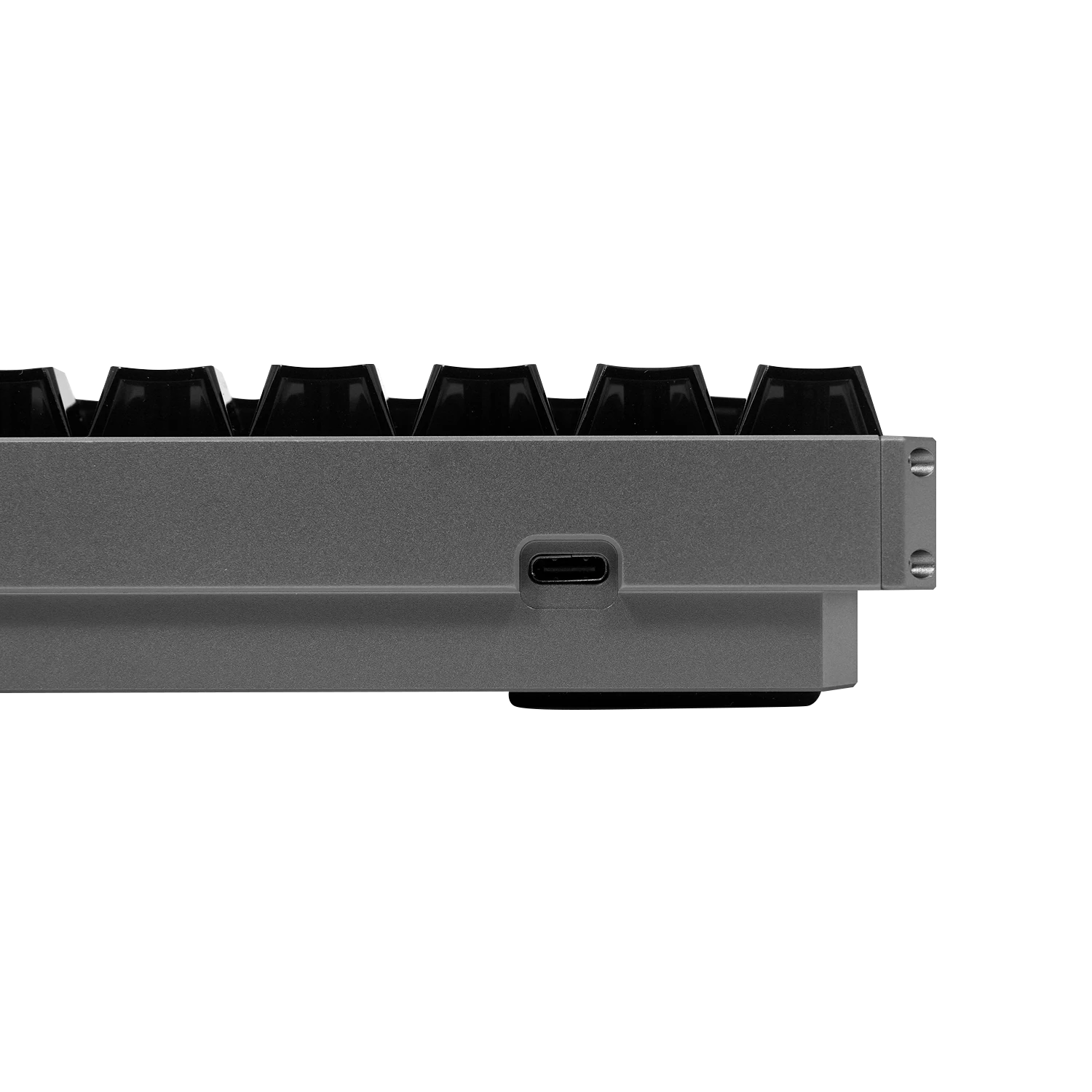 Close-up of the side of a gray mechanical keyboard showing black keycaps and a USB-C port on a white background.