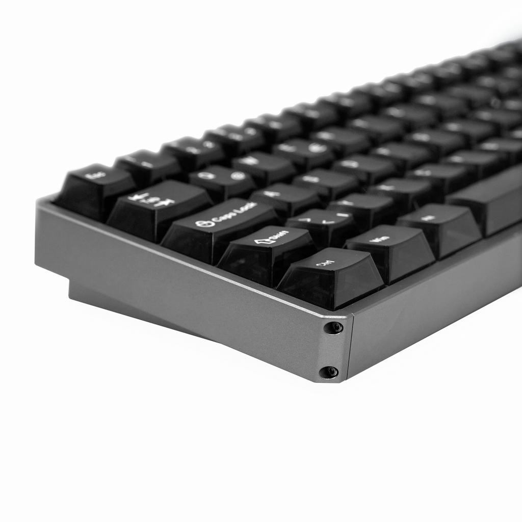 Close-up of a mechanical keyboard showing the side profile with black keycaps, white legends, and a dark gray aluminum chassis on a white background.