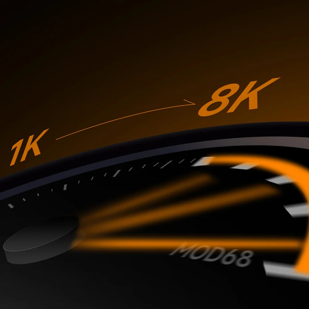 Close-up of a dark speedometer or tachometer gauge with illuminated orange markings reading 1K, 8K, and MOD68 on a black face.