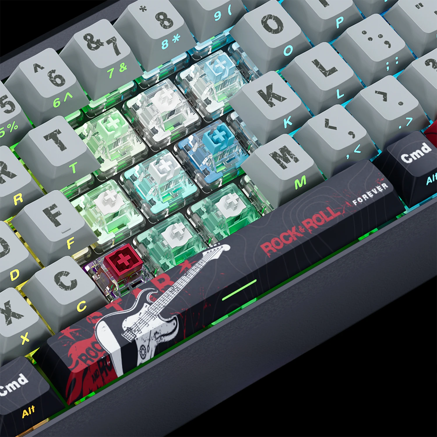 Close-up of a mechanical keyboard featuring translucent green and blue switch capsules, gray keycaps, and a black macro key decorated with a red and white electric guitar graphic and the text 'ROCK-ROLL FOREVER'.