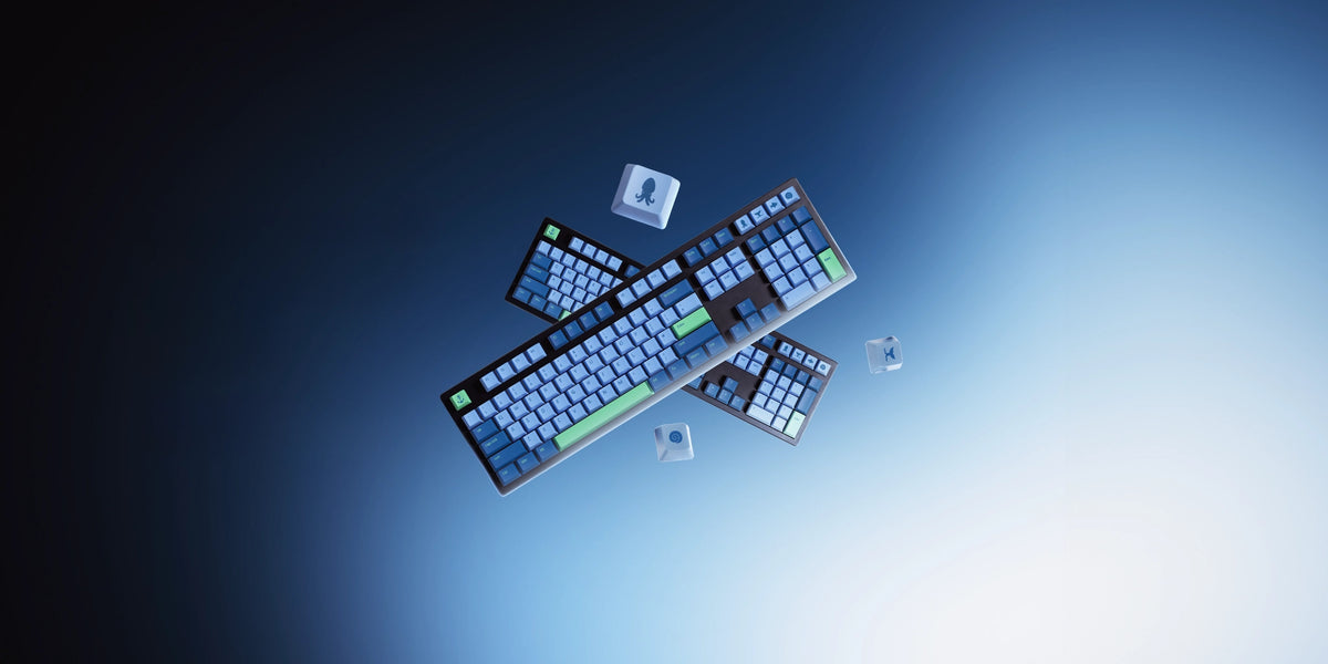 Three compact mechanical keyboards with blue backlighting and green key accents, arranged diagonally against a dark blue to light blue gradient background.
