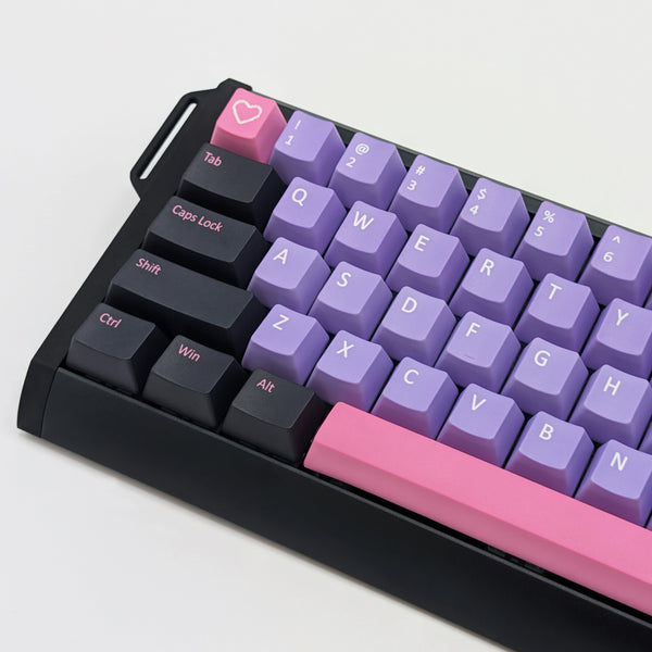 Keyboard with purple and pink keys on a light gray background