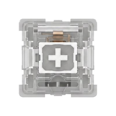 A top-down view of a transparent mechanical keyboard switch keycap, showing the internal structure, copper contacts, and a white central cross symbol on a gray base.